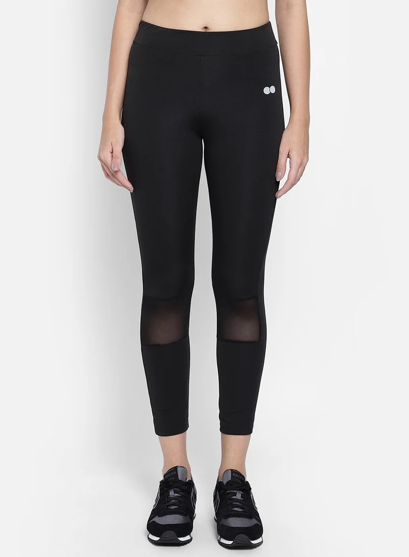 Clovia Black Snug Fit Active Tights in Black with Reflective Logo for Women | Best Price UAE